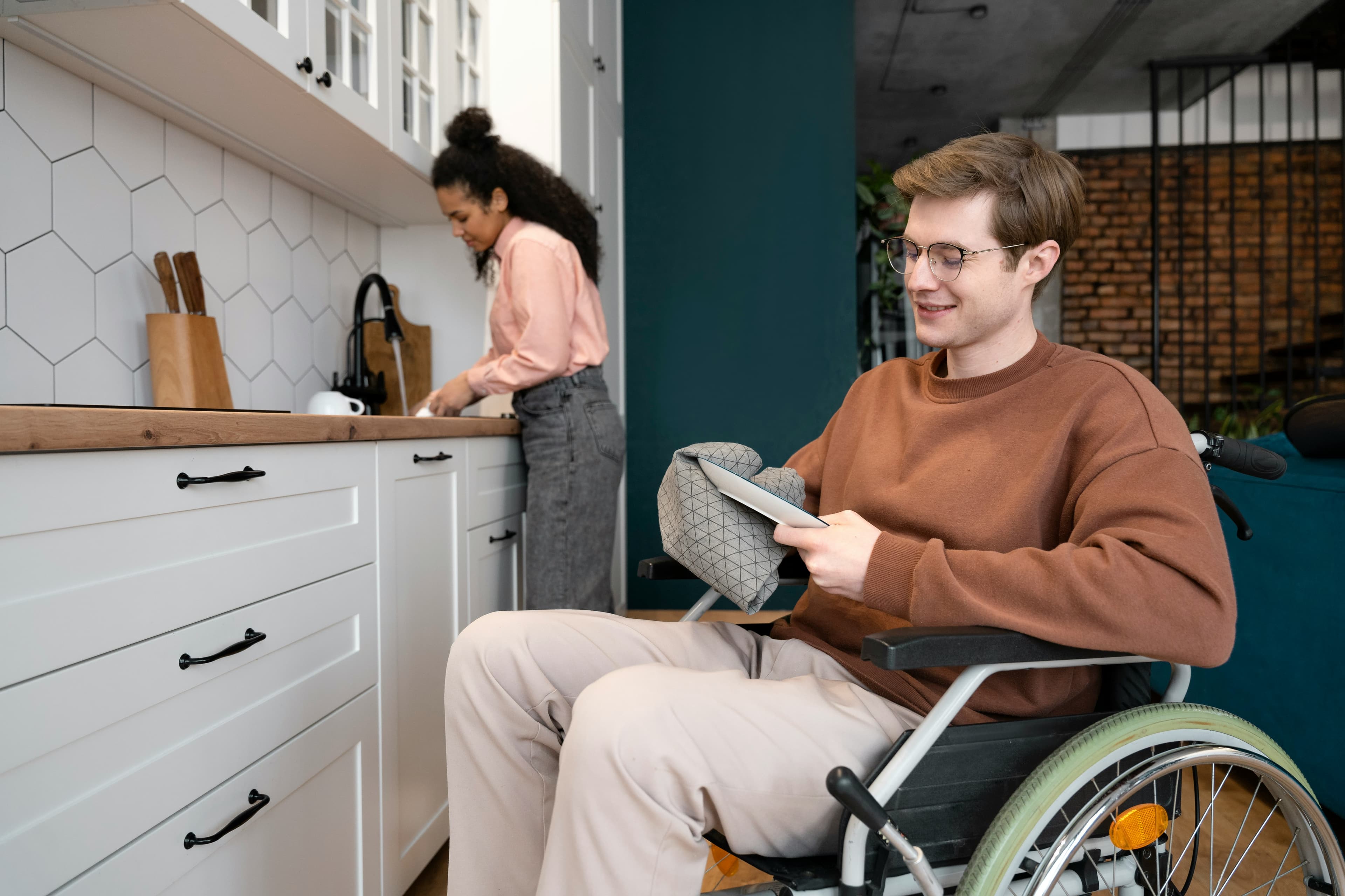 an young adult using wheelchair in his kitchen