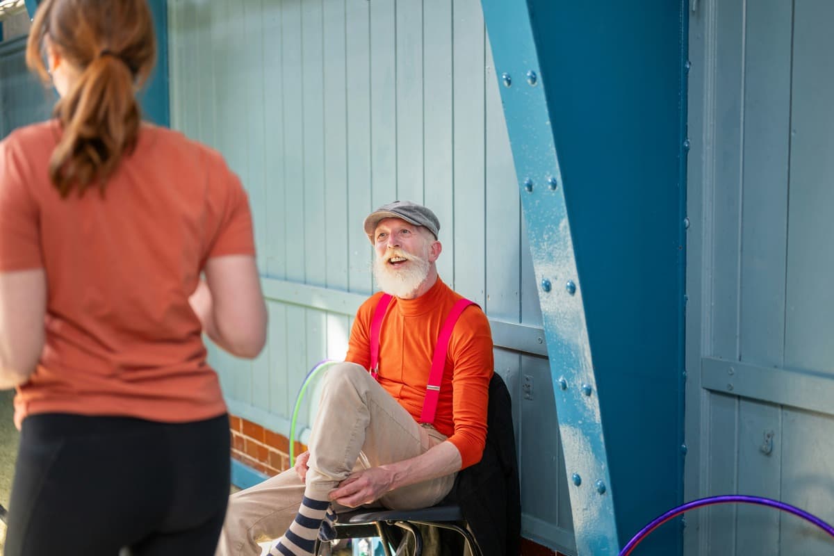 an active male older adult resting on the bench in the public park